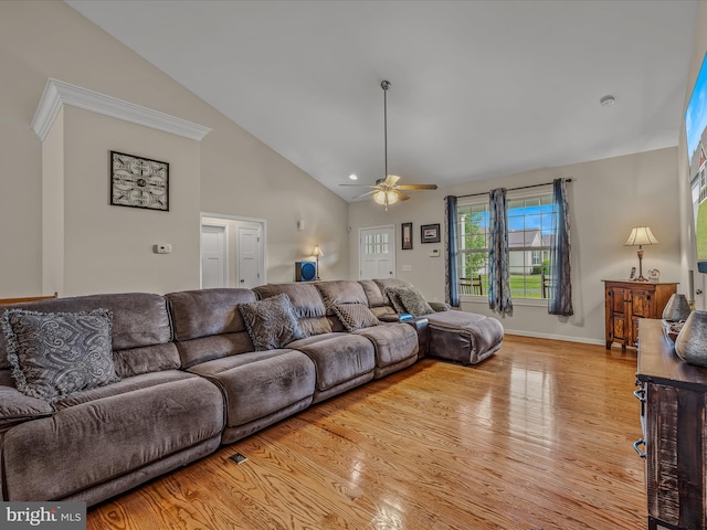 living area featuring a ceiling fan, light wood-style floors, baseboards, and high vaulted ceiling