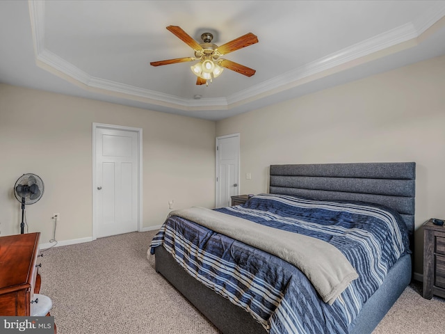bedroom featuring crown molding, carpet floors, a raised ceiling, baseboards, and ceiling fan
