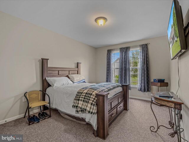carpeted bedroom with baseboards