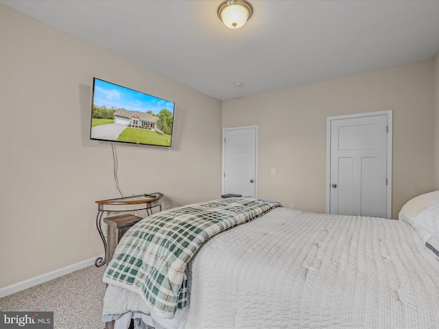 carpeted bedroom featuring baseboards