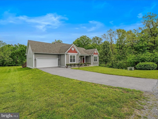 ranch-style house featuring an attached garage, a front lawn, driveway, and roof with shingles