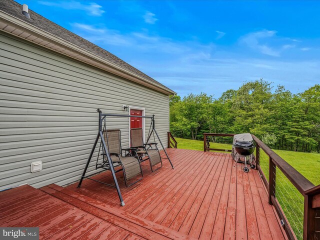 deck with a lawn and area for grilling