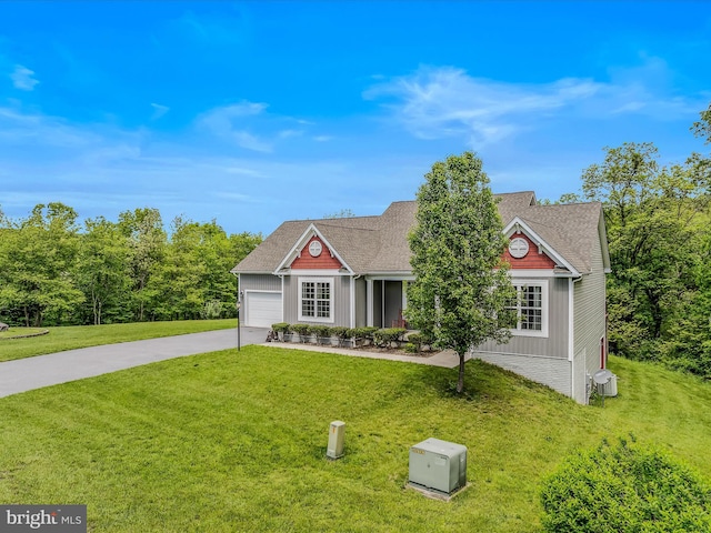 view of front facade with concrete driveway, a front lawn, an attached garage, and roof with shingles