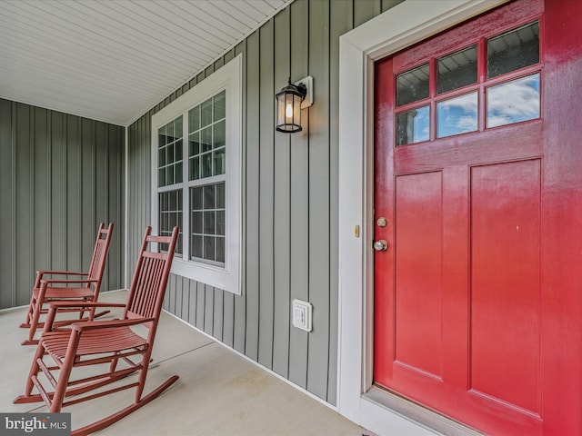 entrance to property featuring covered porch and board and batten siding