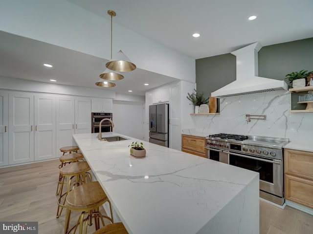 1782 Shaftsbury Ave, Crofton, MD 21114 - kitchen with stainless steel appliances, wall chimney range hood, a sink, backsplash, and light wood-style floors