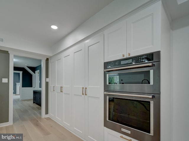 1782 Shaftsbury Ave, Crofton, MD 21114 - kitchen featuring stainless steel double oven, white cabinets, recessed lighting, light wood-style floors, and baseboards