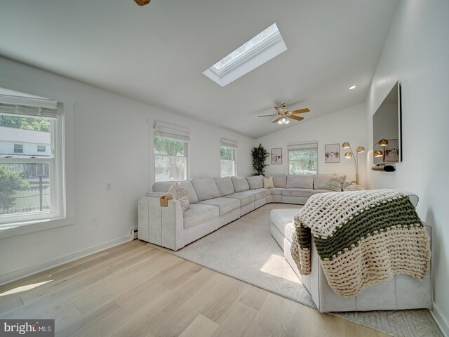 1782 Shaftsbury Ave, Crofton, MD 21114 - living area featuring wood finished floors, a skylight, lofted ceiling, a baseboard heating unit, and ceiling fan
