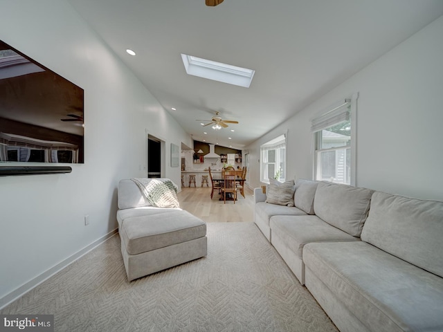 1782 Shaftsbury Ave, Crofton, MD 21114 - living room with a skylight, ceiling fan, vaulted ceiling, baseboards, and wood finished floors