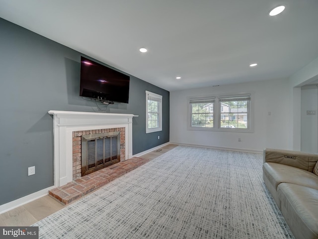 1782 Shaftsbury Ave, Crofton, MD 21114 - living room with a brick fireplace, baseboards, recessed lighting, and wood finished floors