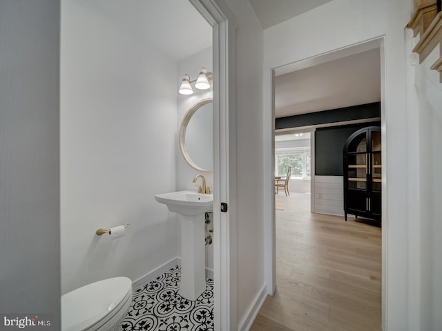 1782 Shaftsbury Ave, Crofton, MD 21114 - half bathroom featuring toilet, baseboards, wood finished floors, and a sink