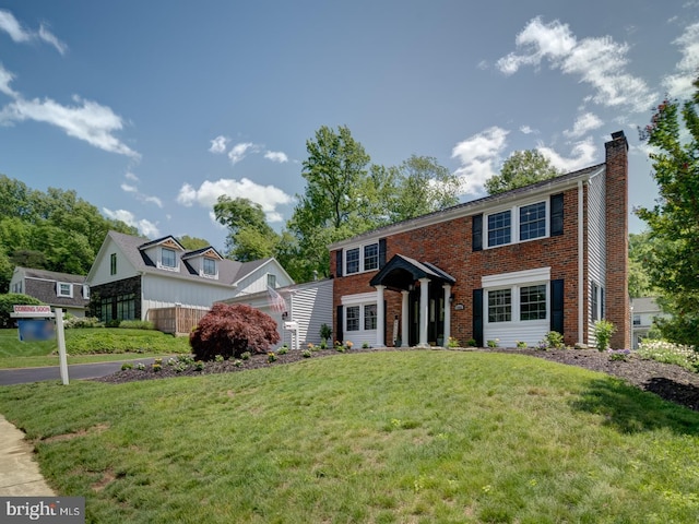 1782 Shaftsbury Ave, Crofton, MD 21114 - colonial house with a chimney, a front lawn, and brick siding