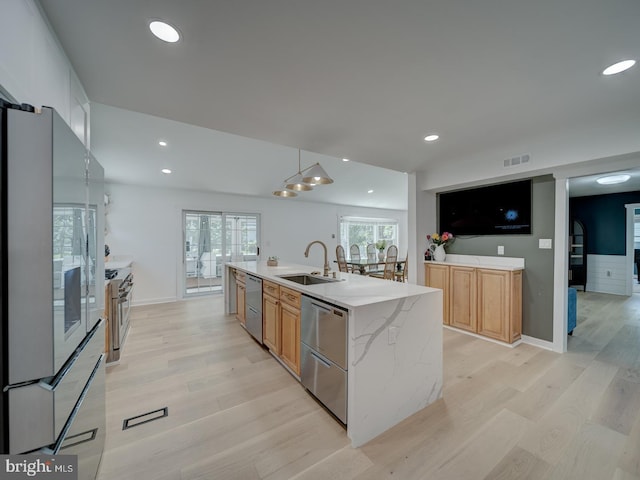 1782 Shaftsbury Ave, Crofton, MD 21114 - kitchen with a sink, stainless steel appliances, light wood-style floors, an island with sink, and light stone countertops
