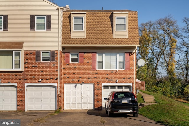 9311 Neil Rd Unit B, Philadelphia, PA 19115 - view of property featuring driveway, brick siding, a shingled roof, and a garage