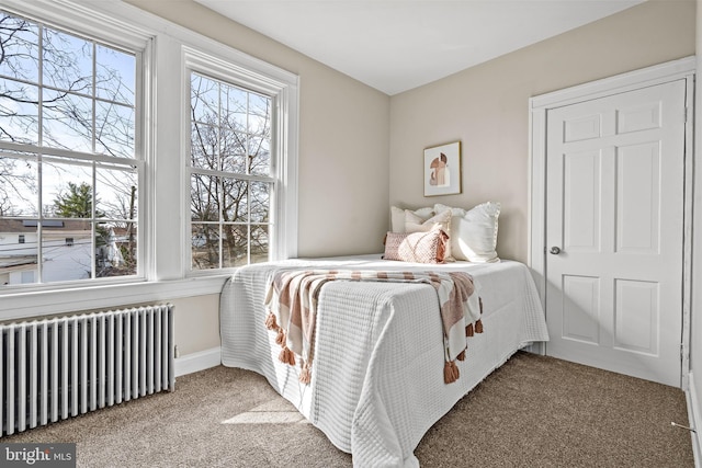 2903 Woodland Ave, Baltimore, MD 21215 - bedroom with baseboards, radiator heating unit, and carpet