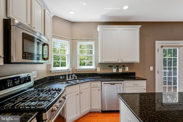 21591 Awbrey Pl, Broadlands, VA 20148 - kitchen featuring appliances with stainless steel finishes, a sink, dark stone counters, white cabinetry, and recessed lighting