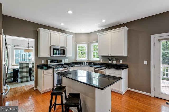 21591 Awbrey Pl, Broadlands, VA 20148 - kitchen with appliances with stainless steel finishes, a sink, light wood-type flooring, white cabinetry, and recessed lighting