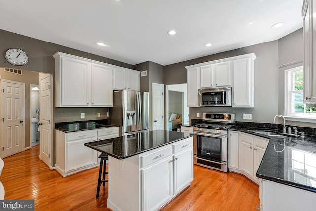 21591 Awbrey Pl, Broadlands, VA 20148 - kitchen with stainless steel appliances, a sink, white cabinetry, light wood-style flooring, and recessed lighting