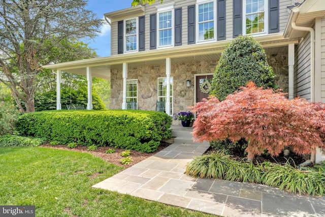 21591 Awbrey Pl, Broadlands, VA 20148 - entrance to property featuring stone siding, covered porch, and a yard