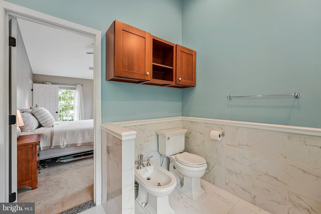 21591 Awbrey Pl, Broadlands, VA 20148 - bathroom with a bidet, connected bathroom, wainscoting, toilet, and tile walls