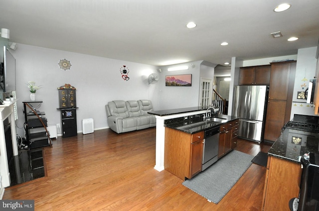 208 Starboard Way, Mount Laurel, NJ 08054 - kitchen featuring appliances with stainless steel finishes, a sink, open floor plan, a center island with sink, and wood finished floors