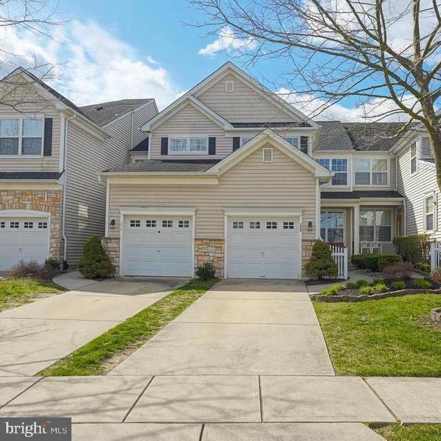 208 Starboard Way, Mount Laurel, NJ 08054 - view of front of house with driveway, stone siding, an attached garage, and a front lawn