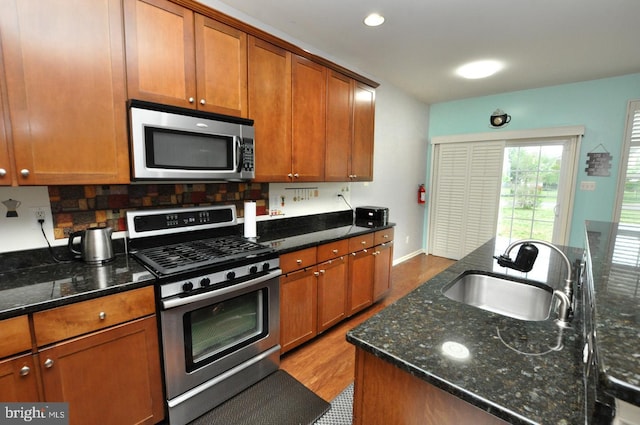 208 Starboard Way, Mount Laurel, NJ 08054 - kitchen with appliances with stainless steel finishes, a sink, brown cabinetry, backsplash, and wood finished floors