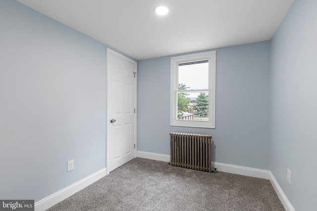 unfurnished room featuring recessed lighting, carpet flooring, baseboards, and radiator heating unit