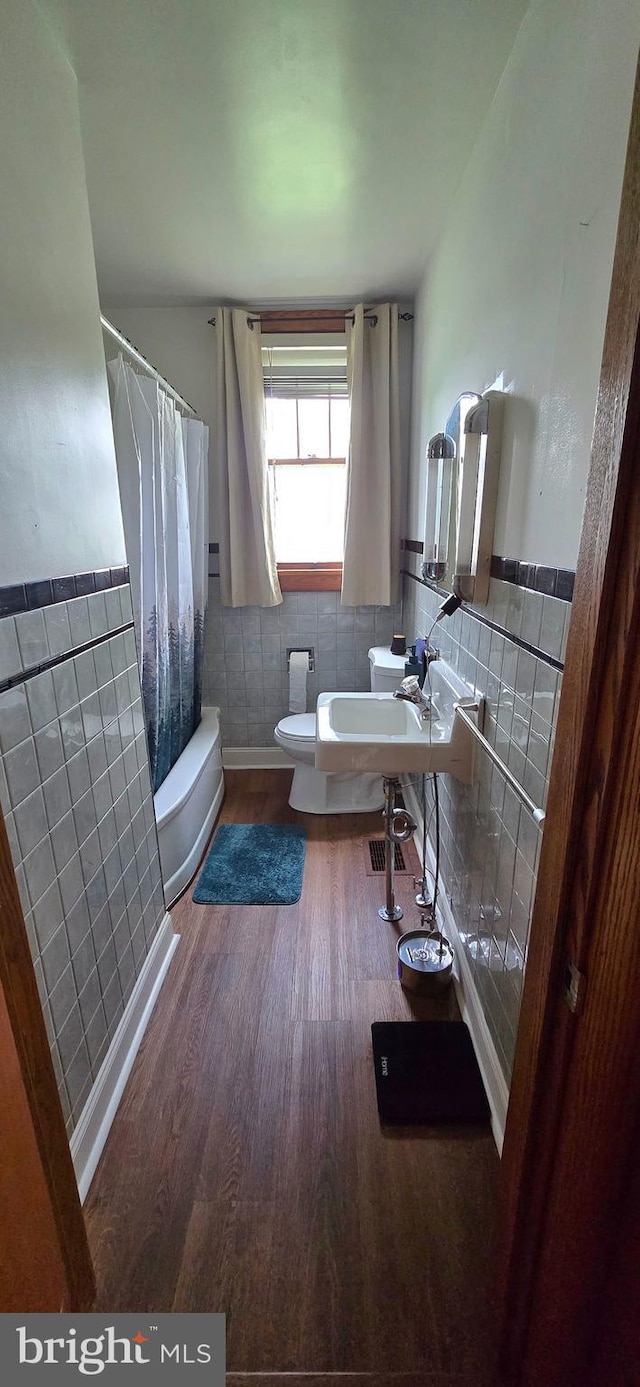 8074 Molly Pitcher Hwy, Shippensburg, PA 17257 - full bath featuring tile walls, wood finished floors, a sink, toilet, and shower / tub combo