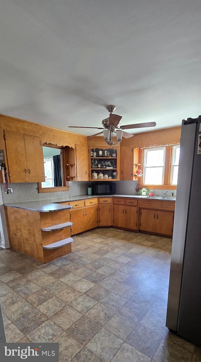 8074 Molly Pitcher Hwy, Shippensburg, PA 17257 - kitchen with open shelves, freestanding refrigerator, stone finish flooring, and a ceiling fan