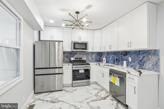 2014 N Marston St, Philadelphia, PA 19121 - kitchen featuring stainless steel appliances, a sink, light marble finish floors, and white cabinetry