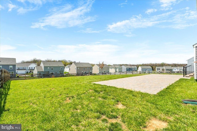 view of yard featuring fence and a residential view