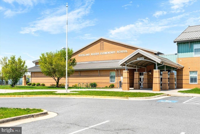 view of building exterior with uncovered parking
