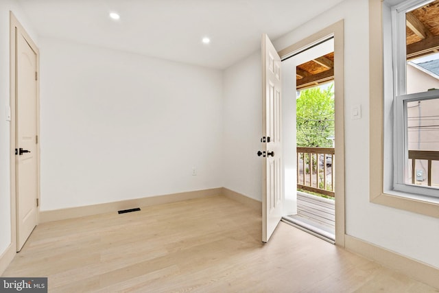 doorway featuring baseboards, recessed lighting, light wood-style flooring, and visible vents