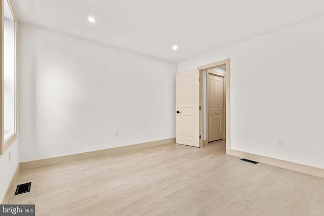 spare room featuring recessed lighting, baseboards, visible vents, and light wood-type flooring
