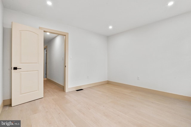 unfurnished room featuring recessed lighting, baseboards, visible vents, and light wood-style floors