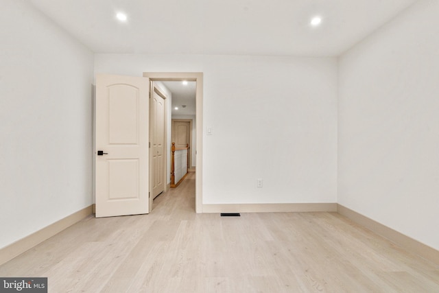 unfurnished room with recessed lighting, light wood-style floors, and baseboards