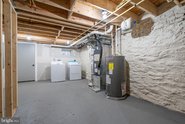 basement featuring separate washer and dryer, heating unit, and water heater