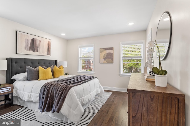 bedroom with recessed lighting, baseboards, multiple windows, and dark wood-style floors