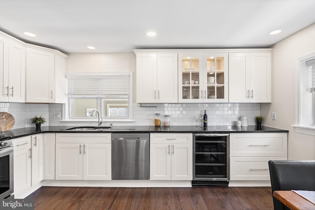 bar with a sink, dishwasher, recessed lighting, wine cooler, and backsplash