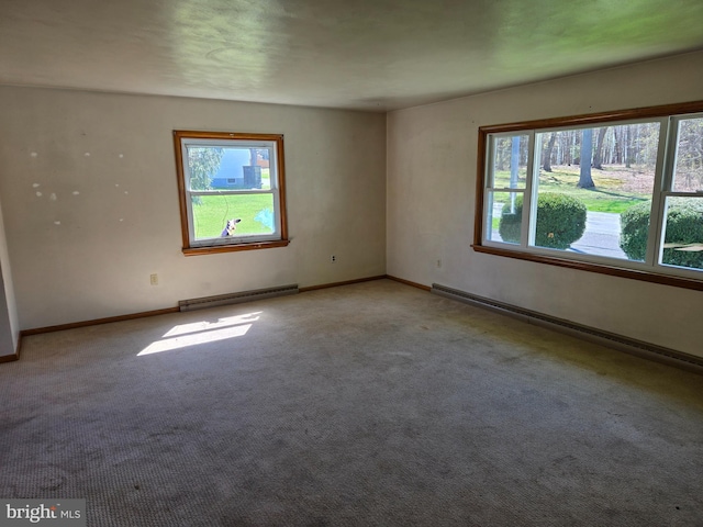 unfurnished room with baseboards, carpet, a baseboard heating unit, and baseboard heating