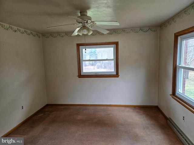 carpeted empty room with baseboards, a baseboard radiator, and ceiling fan