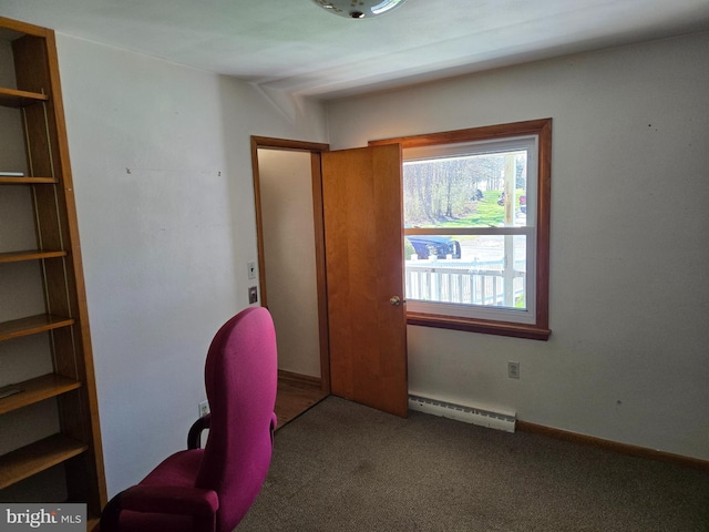 carpeted office space featuring a baseboard heating unit
