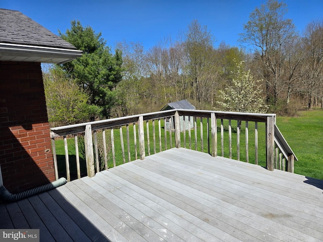 wooden terrace featuring a lawn