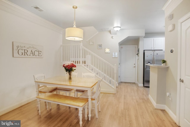 2350 Merseyside Dr, Woodbridge, VA 22191 - dining room with stairs, light wood finished floors, and baseboards