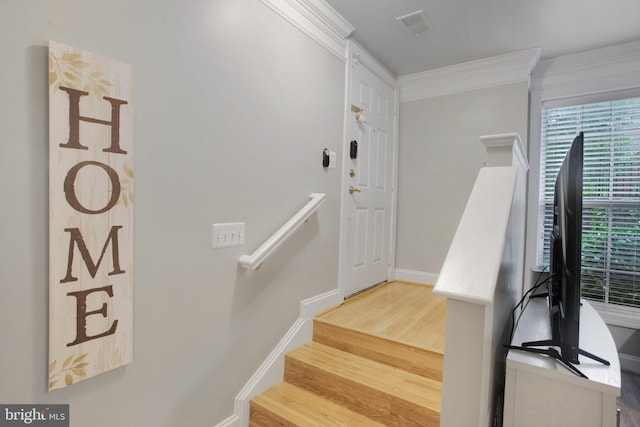 2350 Merseyside Dr, Woodbridge, VA 22191 - stairway featuring wood finished floors, crown molding, and baseboards