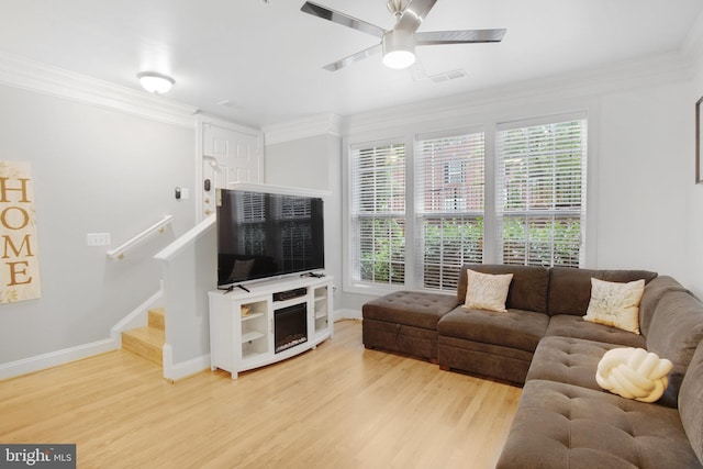 2350 Merseyside Dr, Woodbridge, VA 22191 - living room with wood finished floors, baseboards, crown molding, a ceiling fan, and stairs