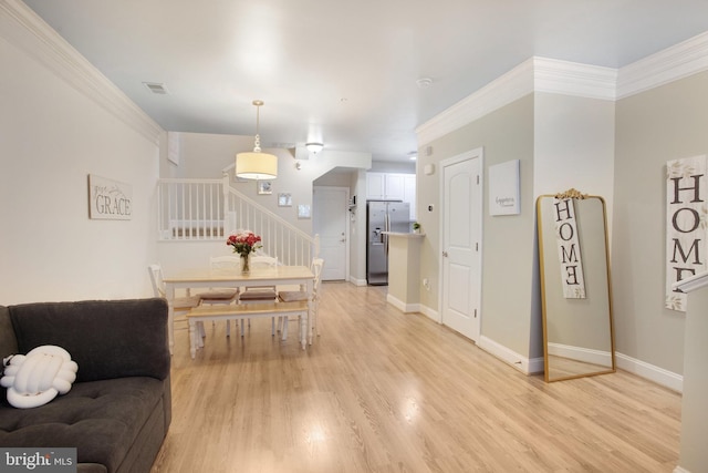 2350 Merseyside Dr, Woodbridge, VA 22191 - dining space featuring stairway, light wood-style floors, baseboards, and ornamental molding