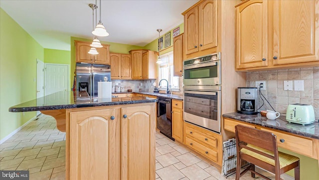 kitchen featuring appliances with stainless steel finishes, a center island, a sink, tasteful backsplash, and light brown cabinetry