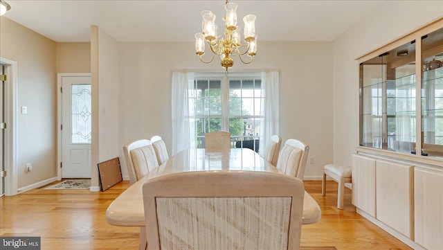 dining room featuring a chandelier and light wood-type flooring