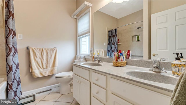 bathroom featuring tile patterned floors, toilet, double vanity, and baseboards